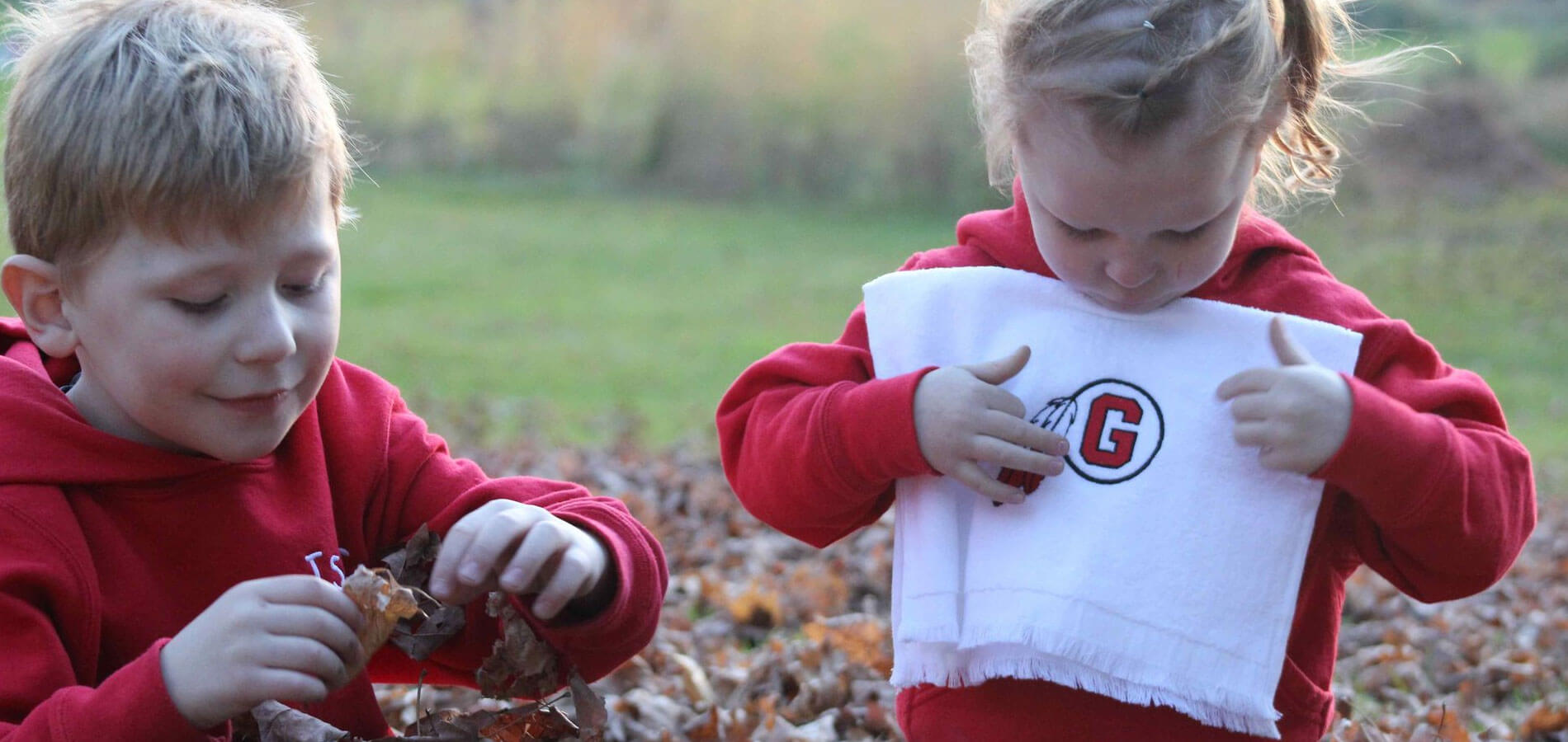Children Outdoors Playing In Leaves