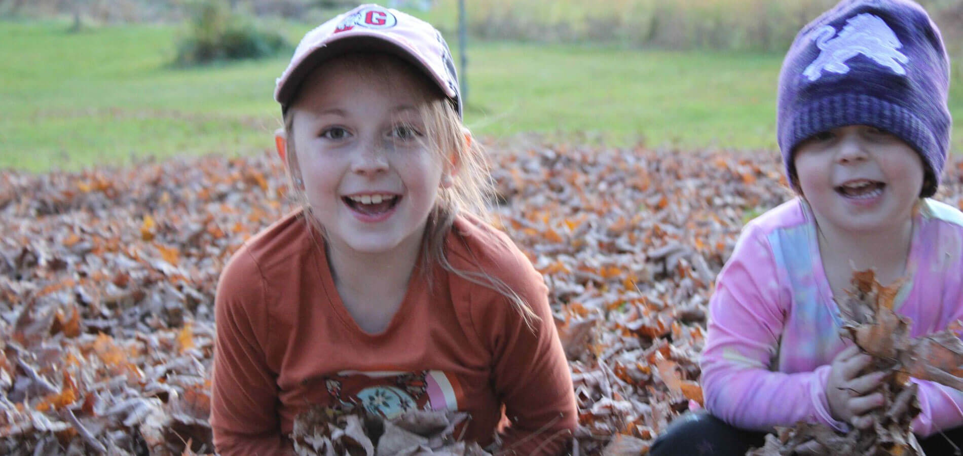 Girls Playing In Leaves